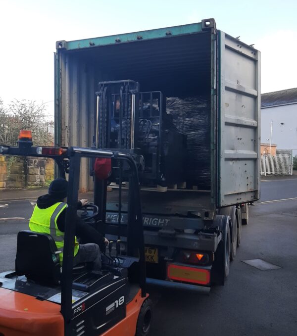 Fire Cloaks being loaded into the shipment container headed for the US